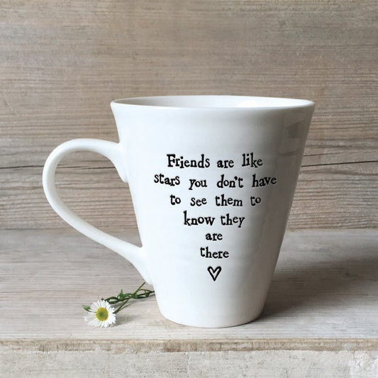White mug with a motivational quote on a wooden surface