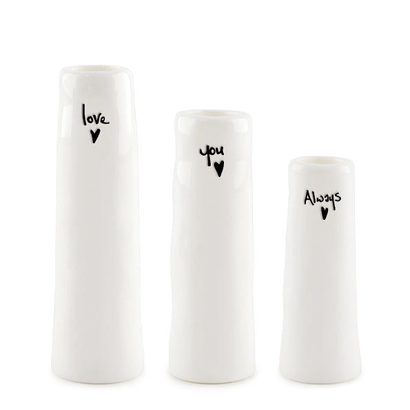 Three white vases with black text and heart symbols on a white background