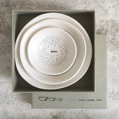 Set of three ceramic bowls in a box with 'Love' text on a textured surface