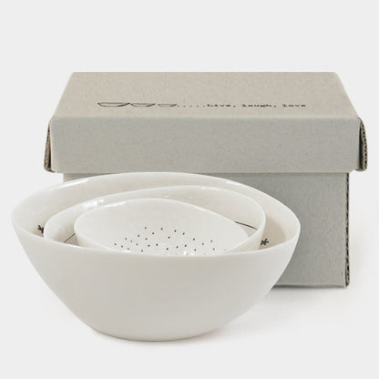 Set of white ceramic bowls with a box on a white background