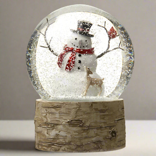 Snow globe with a snowman and deer inside, on a wooden base.