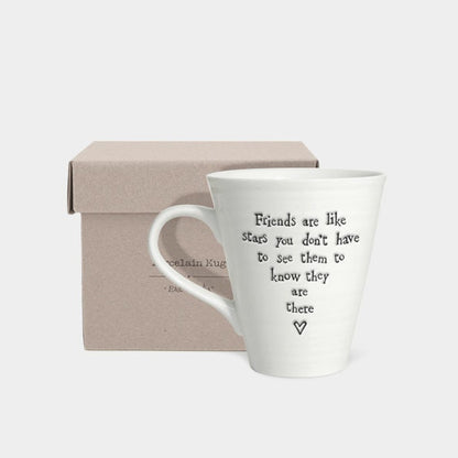 White mug with text in a box on a light gray background
