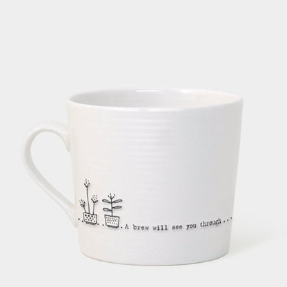 White mug with a black text and flower design on a white background