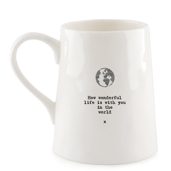 White mug with a black text and globe design on a white background