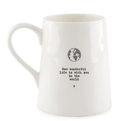 White mug with a black text and globe design on a white background