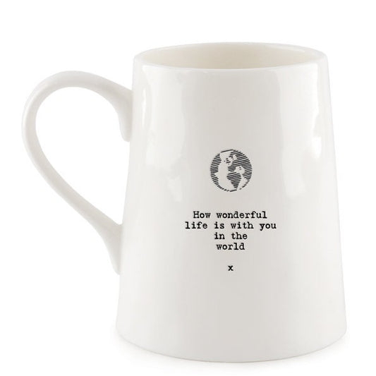 White mug with a black text and globe design on a white background