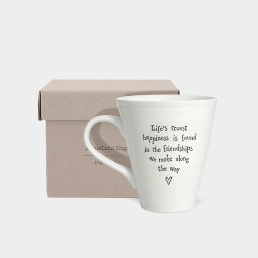 White mug with text in a box on a light gray background
