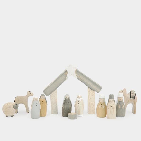 Wooden nativity set with stable on a white background