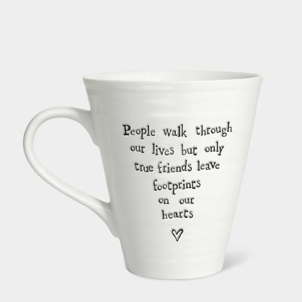 White mug with black text and heart symbol on a white background